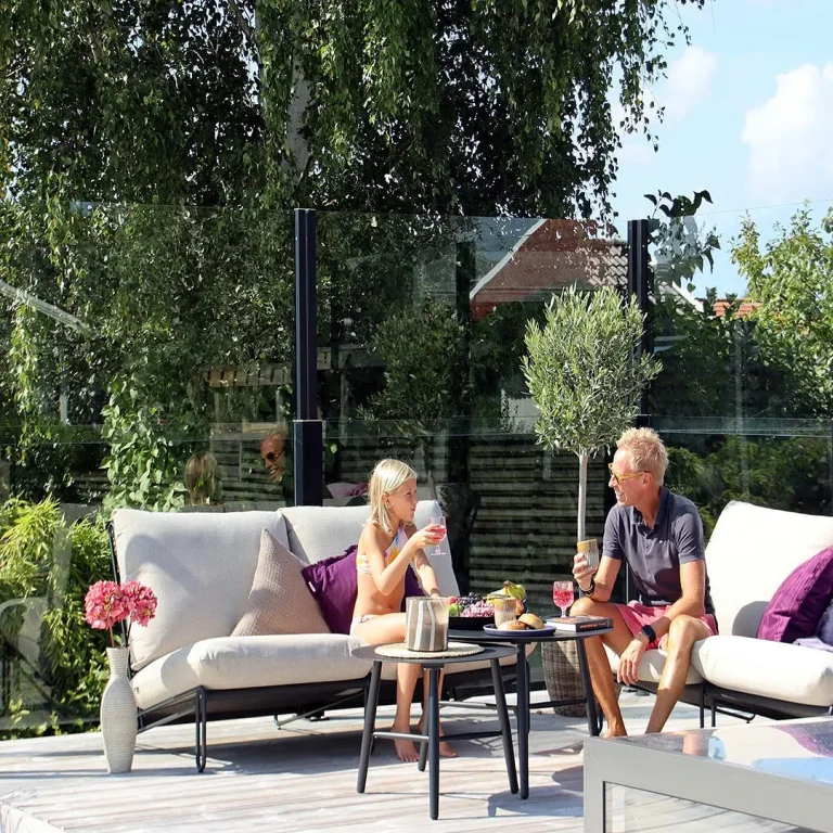 Private patio with retractable glass railing – stylish wind protection