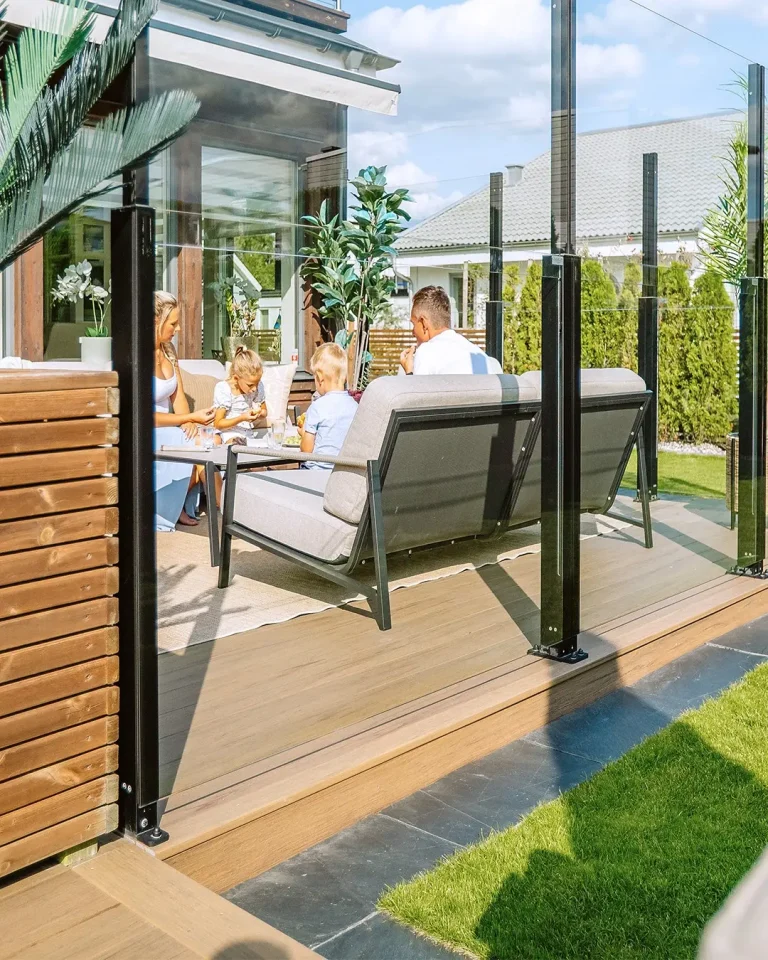 Family enjoying retractable glass railing terrace – safe and comfortable