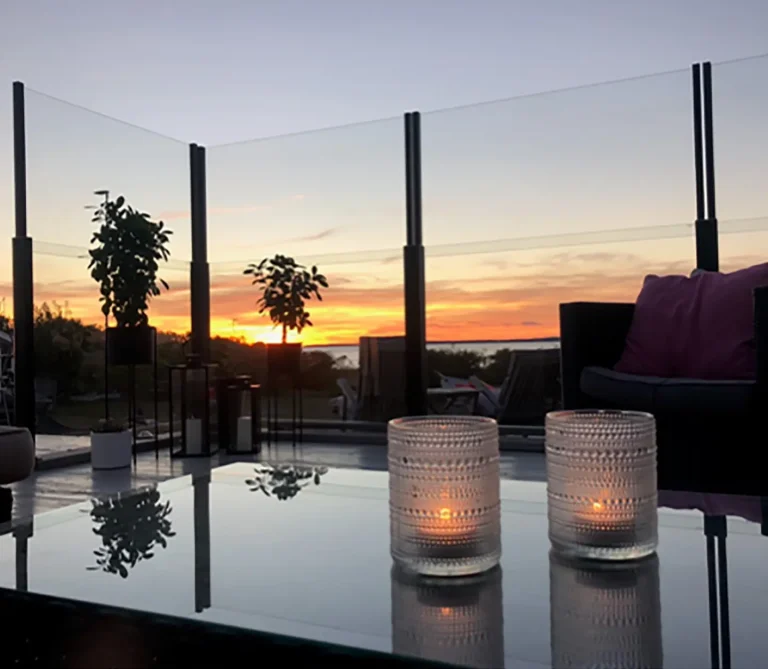 Evening terrace with retractable glass railing and candles – ClickitUp®